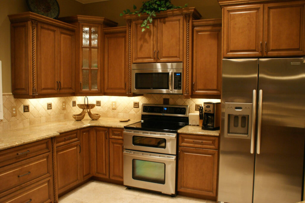 Traditional kitchen design with wooden cabinets, granite countertops, tiled backsplash, and stainless steel appliances